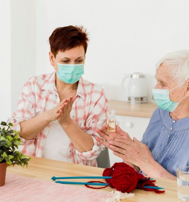 elder-women-disinfecting-their-hands-while-home_23-2148492252